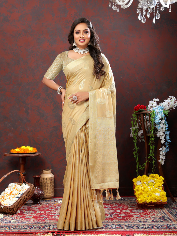 Elegant beige saree featuring delicate zari work and tassels at the pallu, perfect for festive occasions.