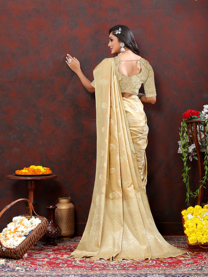 Beautiful beige cotton saree with delicate zari work and tassels at the pallu, ideal for elegant gatherings.