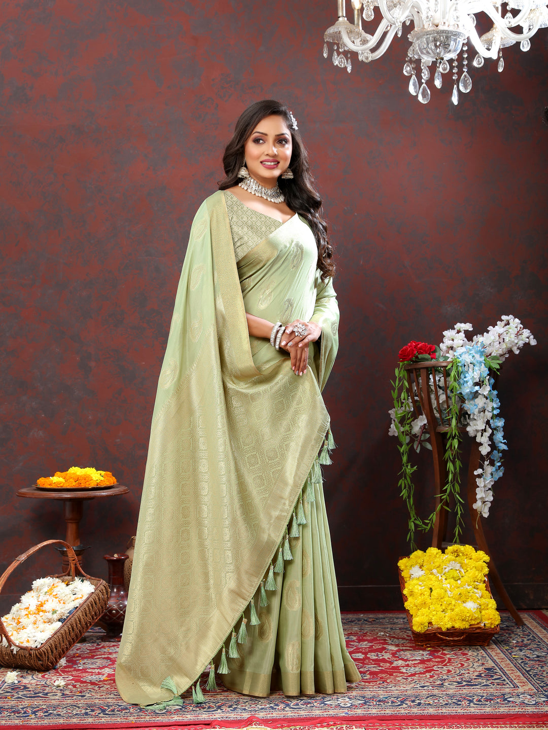 Soft pista green cotton saree with delicate zari work and tassels at the pallu, perfect for cultural celebrations.