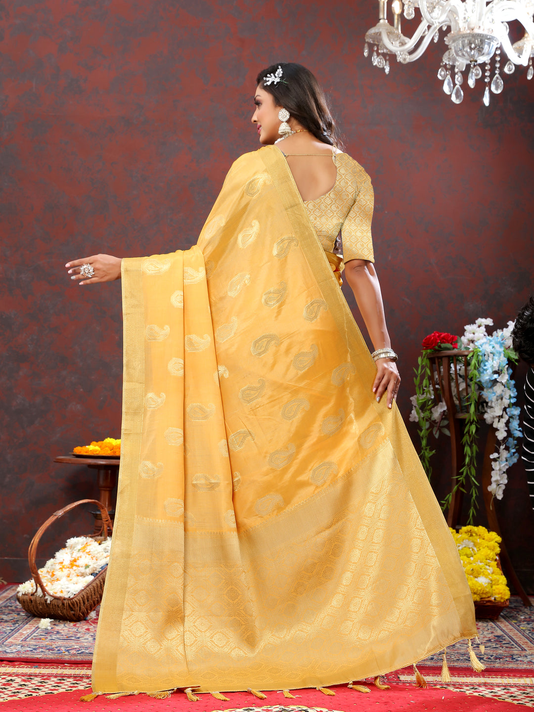 Graceful yellow saree with intricate zari detailing and tassels at the pallu, ideal for cultural celebrations.