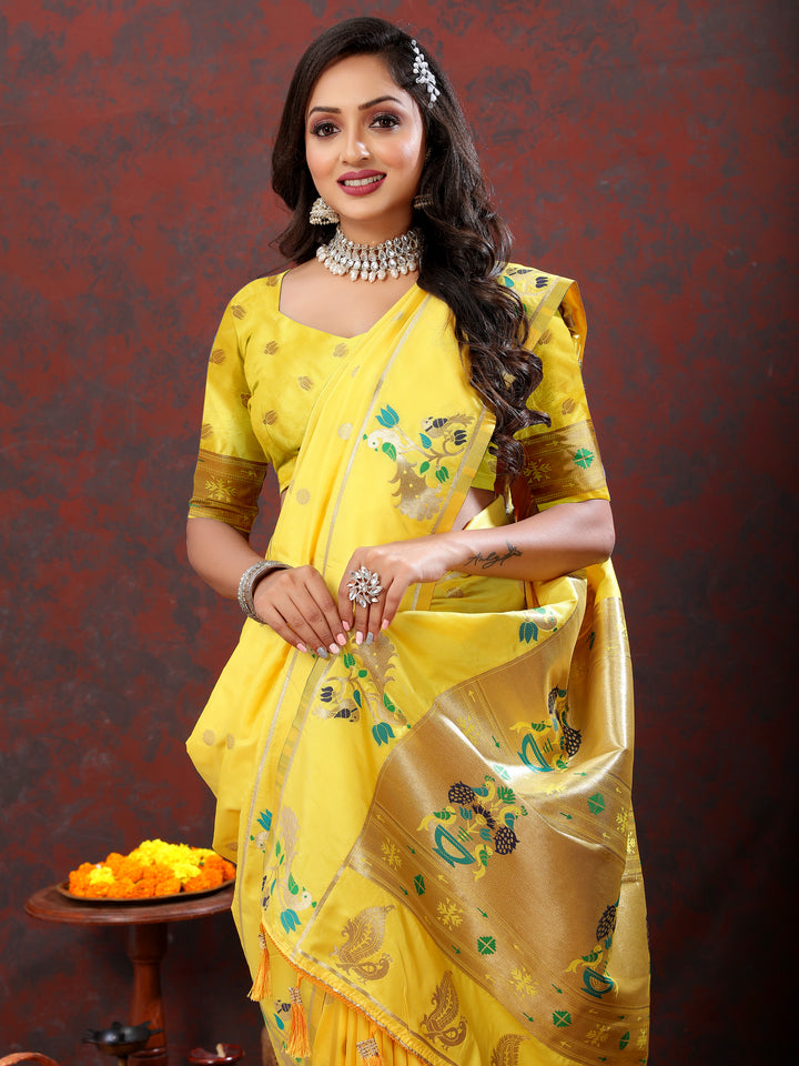 Designer yellow Paithani silk saree with gold zari motifs and Meenakari border for grand events.