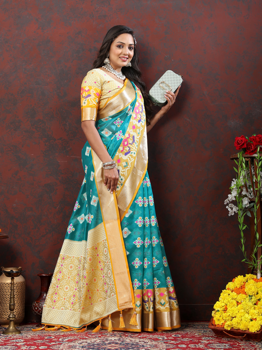 Sky blue silk saree featuring intricate Meenakari motifs and rich zari accents.