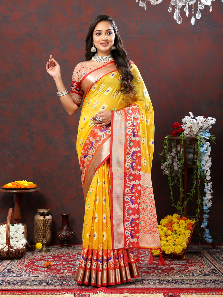 Stunning yellow organza silk saree with Meenakari weaving for special occasions.