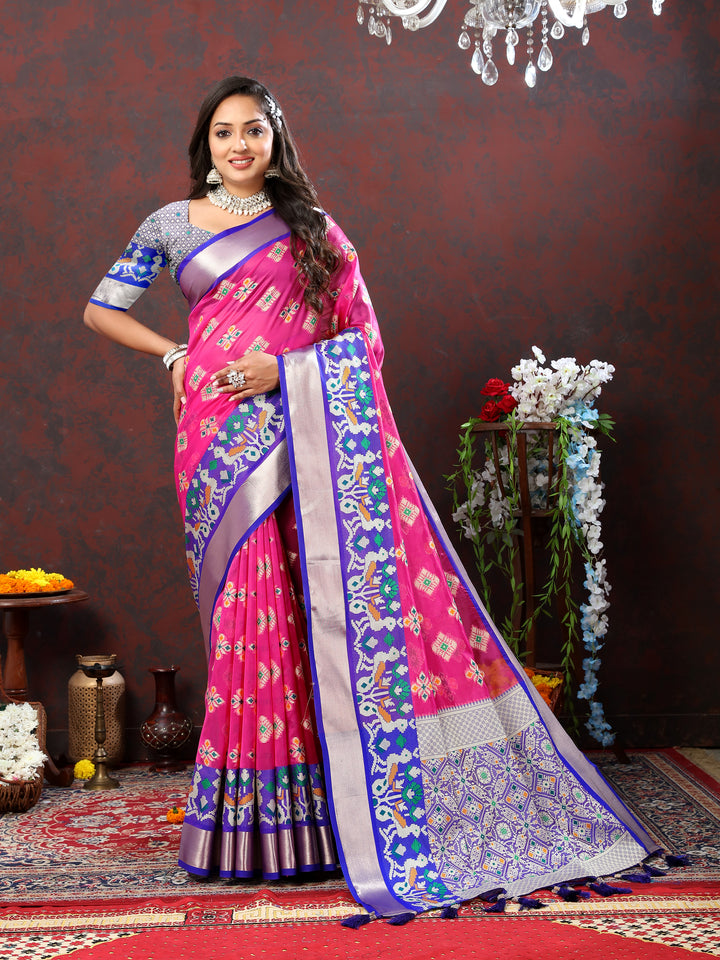 Pink organza silk saree featuring intricate Meenakari weaving and zari details.