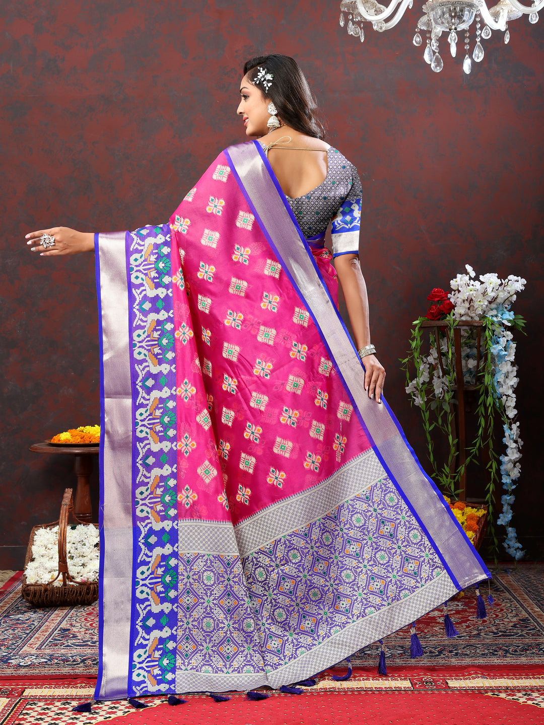 Pink saree with zari border and Meenakari weaving, ideal for wedding events.