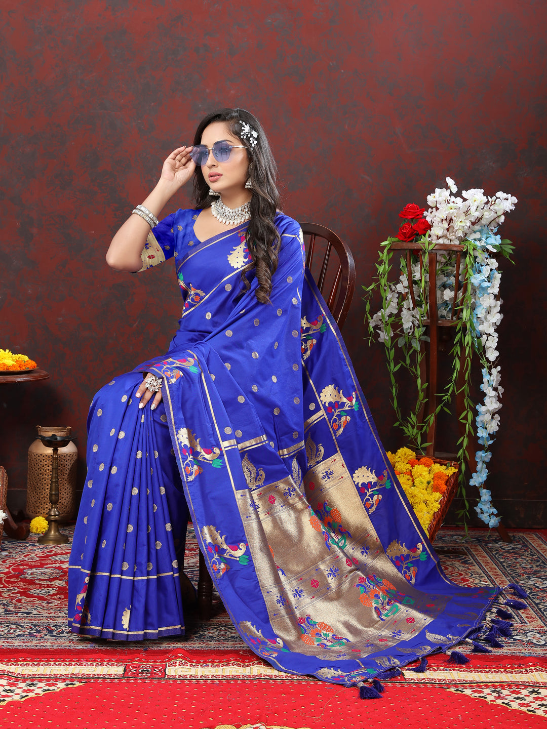 Elegant dark blue Paithani silk saree with gold zari motifs and Meenakari border for weddings and parties.