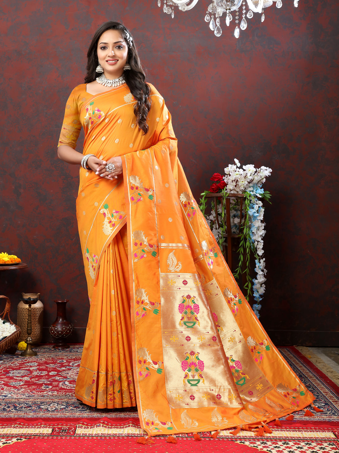 Soft orange Paithani silk saree featuring gold zari motifs and Meenakari border for festive events.