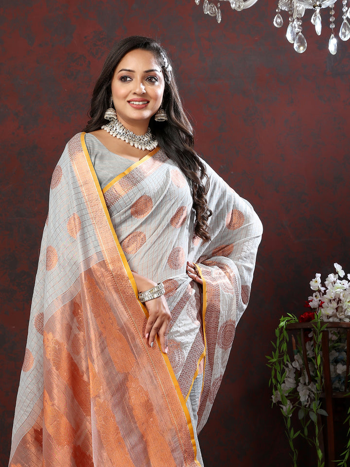 Grey cotton saree with detailed zari work, perfect for formal occasions and festivals.