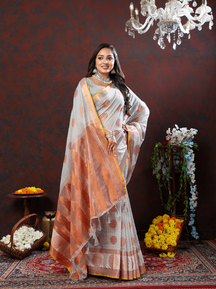 Designer grey cotton saree with luxurious zari woven details, perfect for festive gatherings.