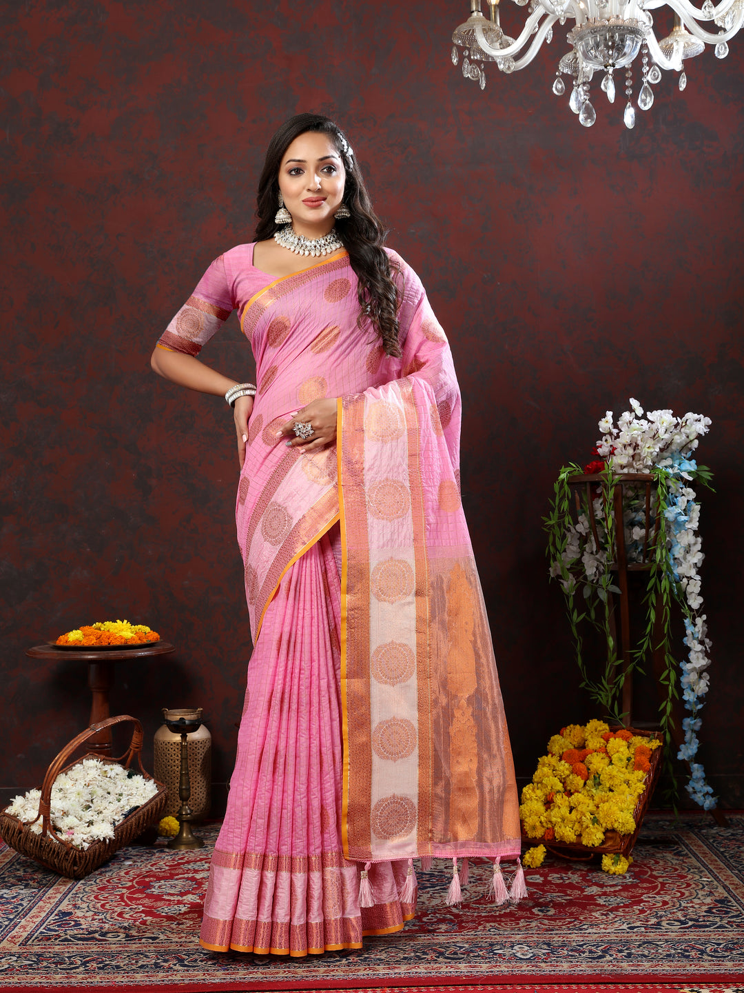 Timeless pink cotton saree with stunning zari woven details, ideal for cultural gatherings.