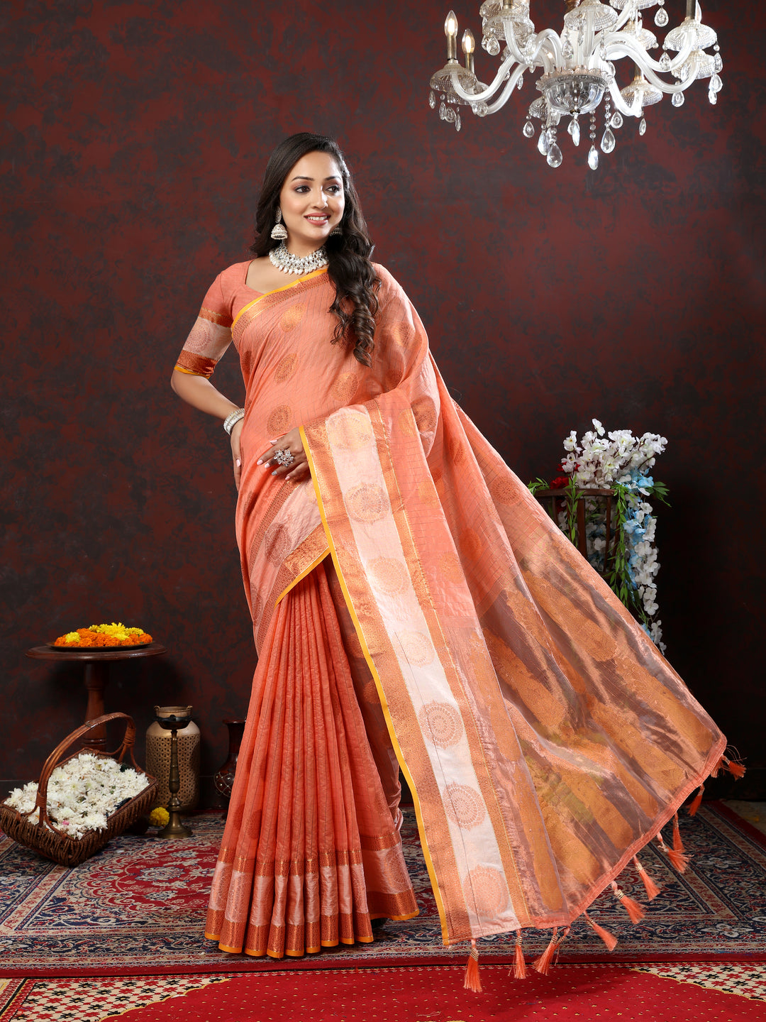 Orange cotton saree with exquisite zari details, ideal for festive events and grand celebrations.