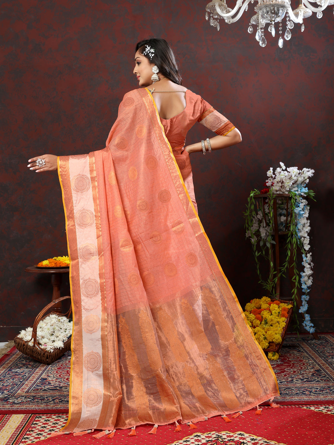 Timeless orange saree with intricate zari woven designs, ideal for weddings and cultural events.