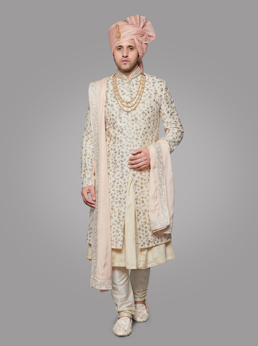 This fawn silk sherwani features all-over embroidery, adding elegance and traditional flair.