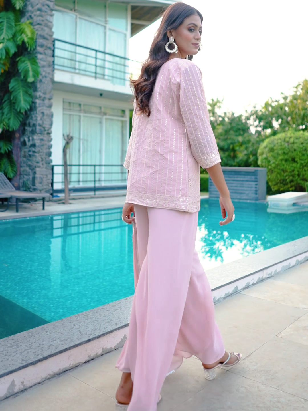 Stylish pink georgette palazzo featuring intricate details, perfect for parties.