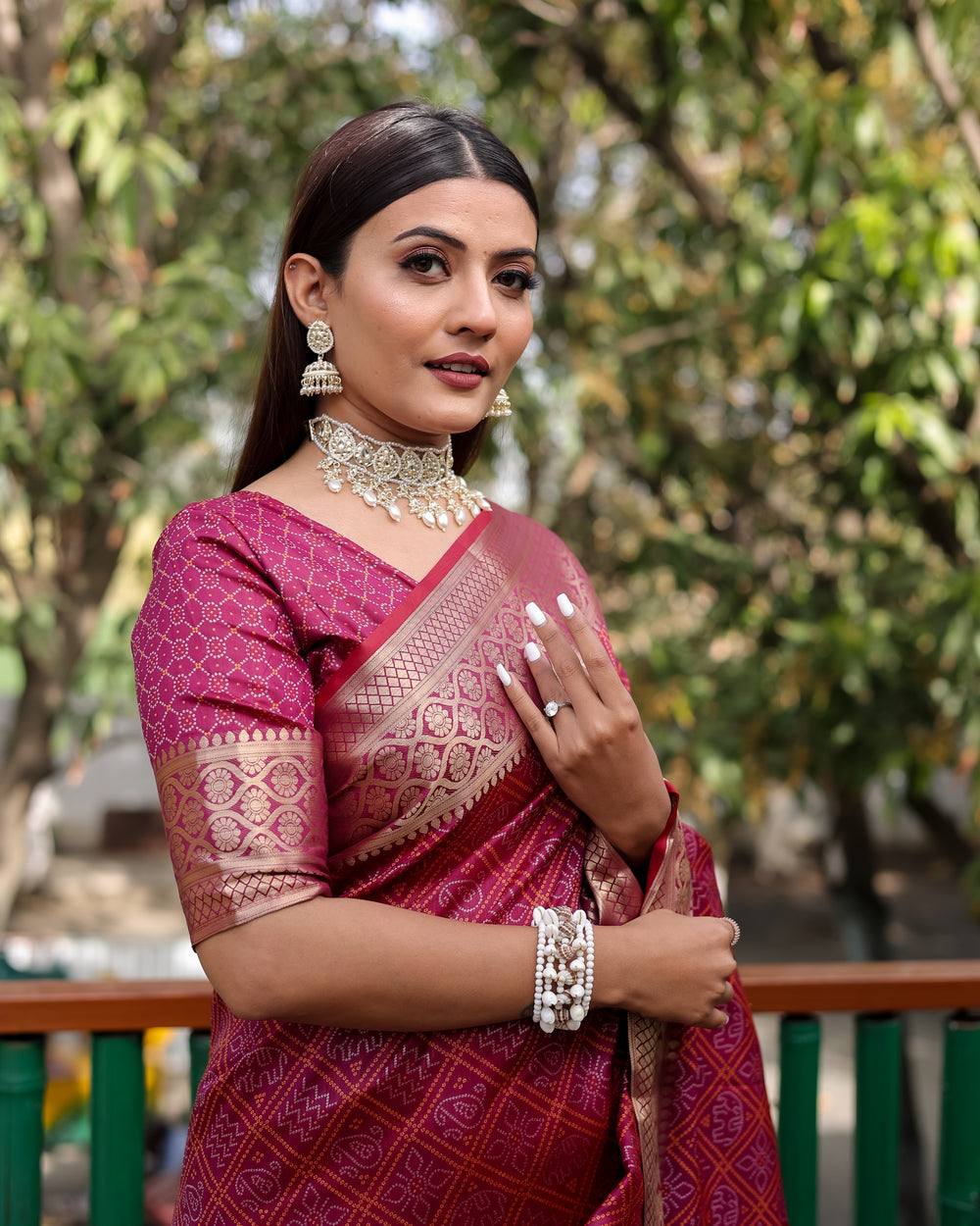 Luxurious maroon Indian saree featuring beautiful zari weaving and a vibrant contrast zari border, perfect for celebrations.