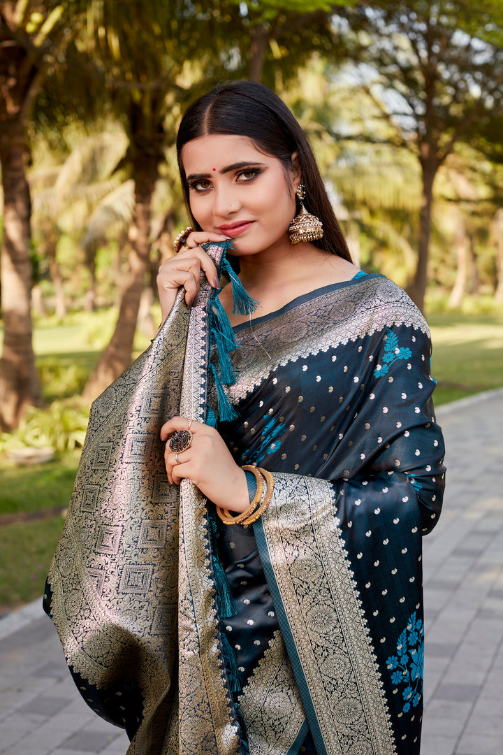 Elegant teal-blue Satin Kanjivaram saree with detailed butta motifs and soft shimmer.