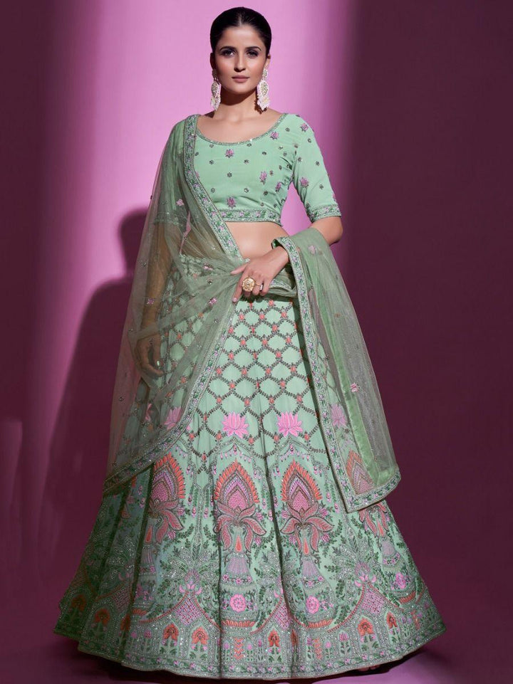 Pista green georgette lehenga choli with thread embroidery and stonework.