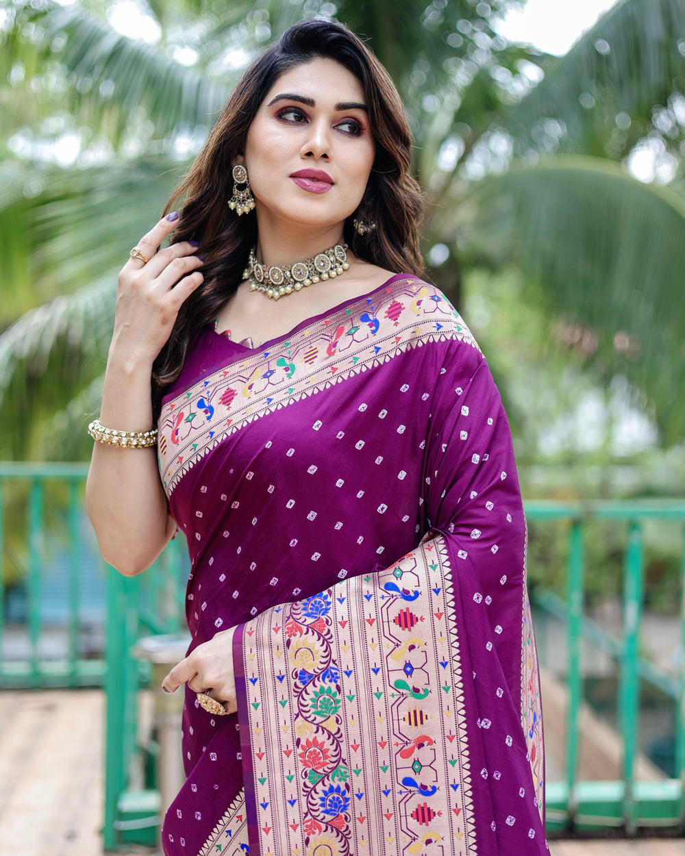 Elegant Paithani Bandhej silk sadi featuring rich traditional weaving in purple, green, and blue.