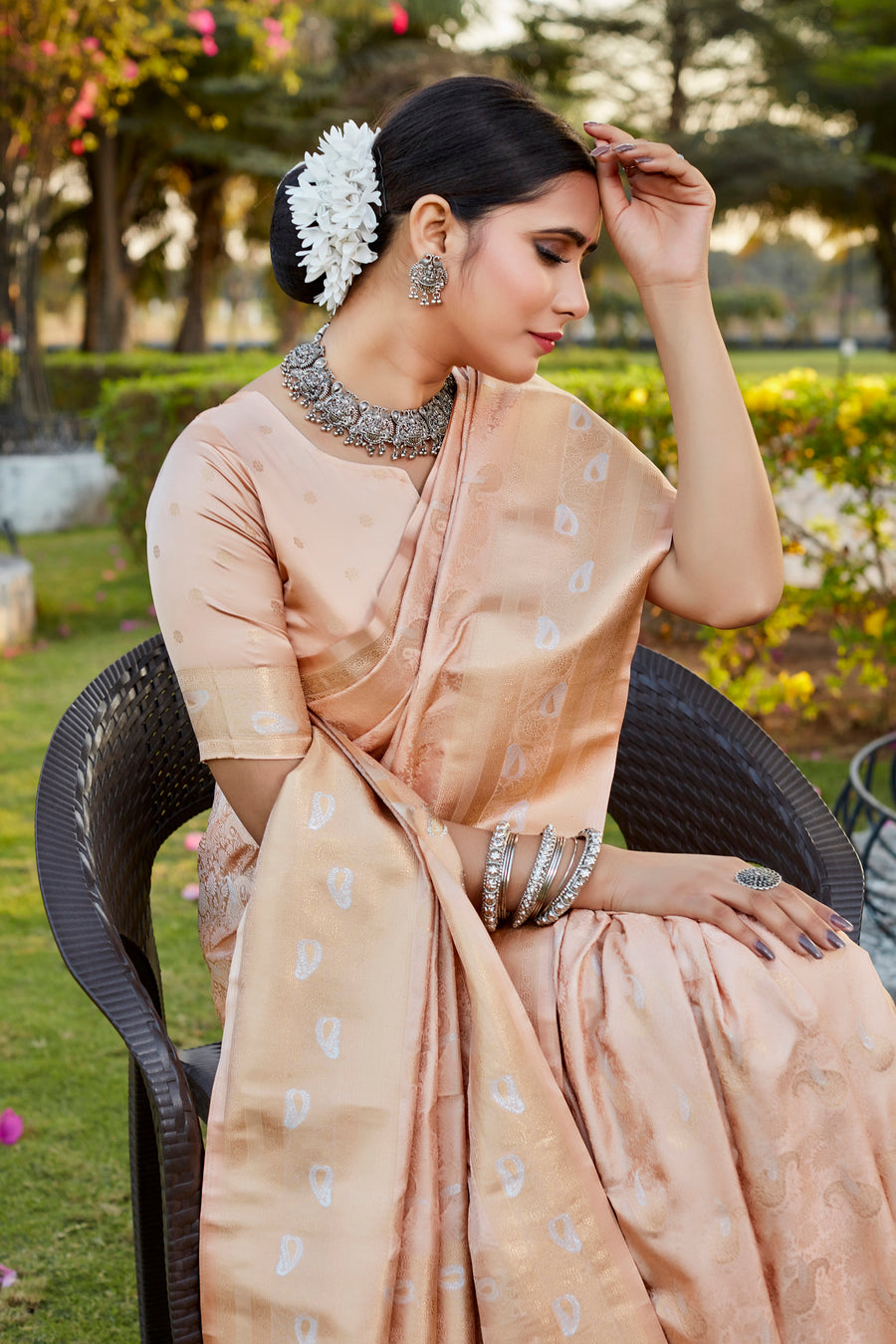 Elegant beige Kanjivaram satin silk saree with intricate butta work and woven pallu, perfect for festive occasions.