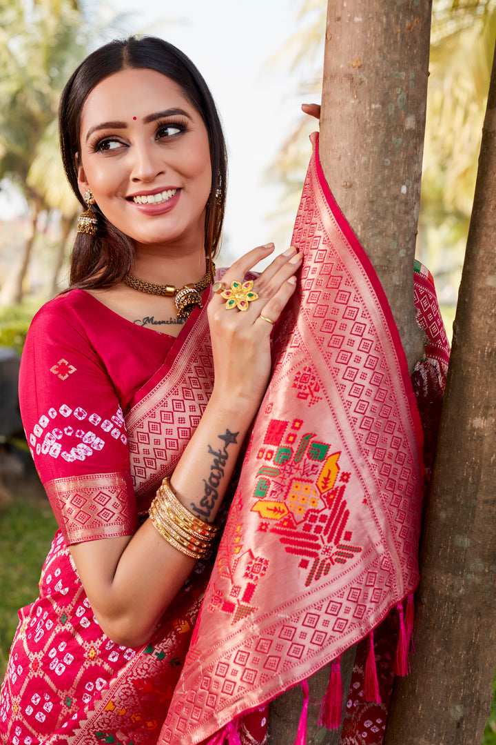 Stunning hot pink Gharchola Bandhej silk saree with a delicate meenakari border, adding elegance to any special occasion or celebration.