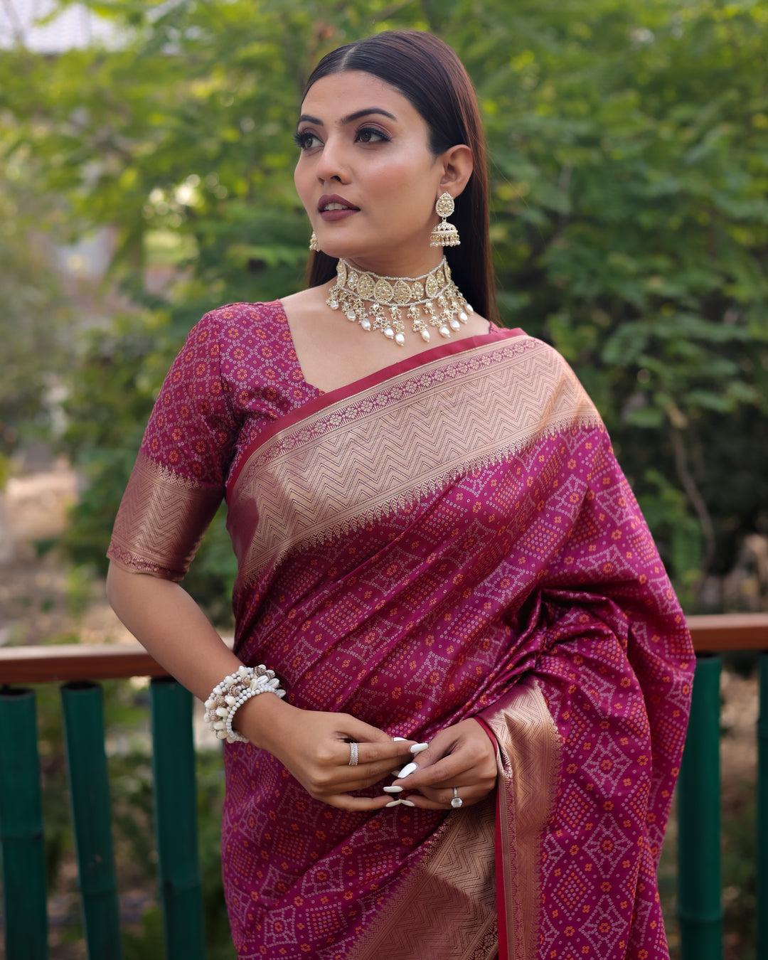 Luxurious maroon Bandhej Patola silk saree featuring intricate zari weaving and elegant patterns, perfect for cultural celebrations.