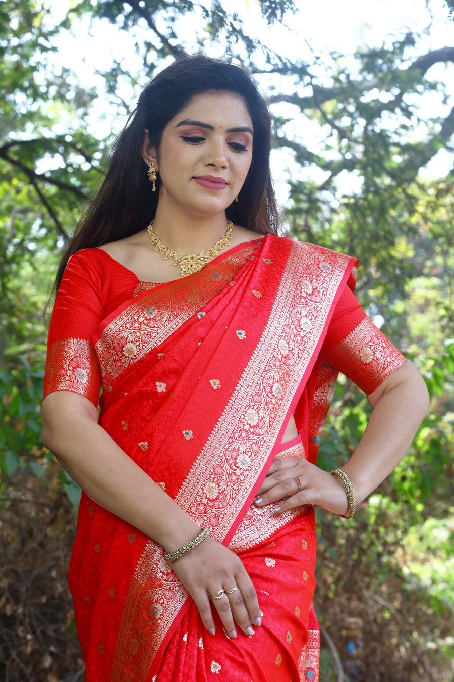 Stylish red Kanjivaram silk saree with radiant shine and intricate weaving, perfect for festive occasions.