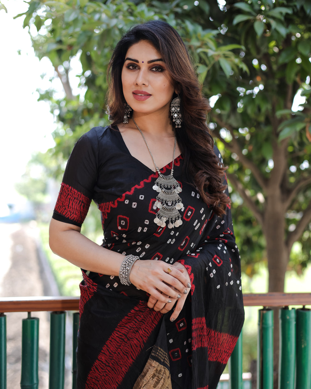 Stunning black Bandhej silk saree featuring a gorgeous combination of traditional weaving and elegant Sibory motifs.