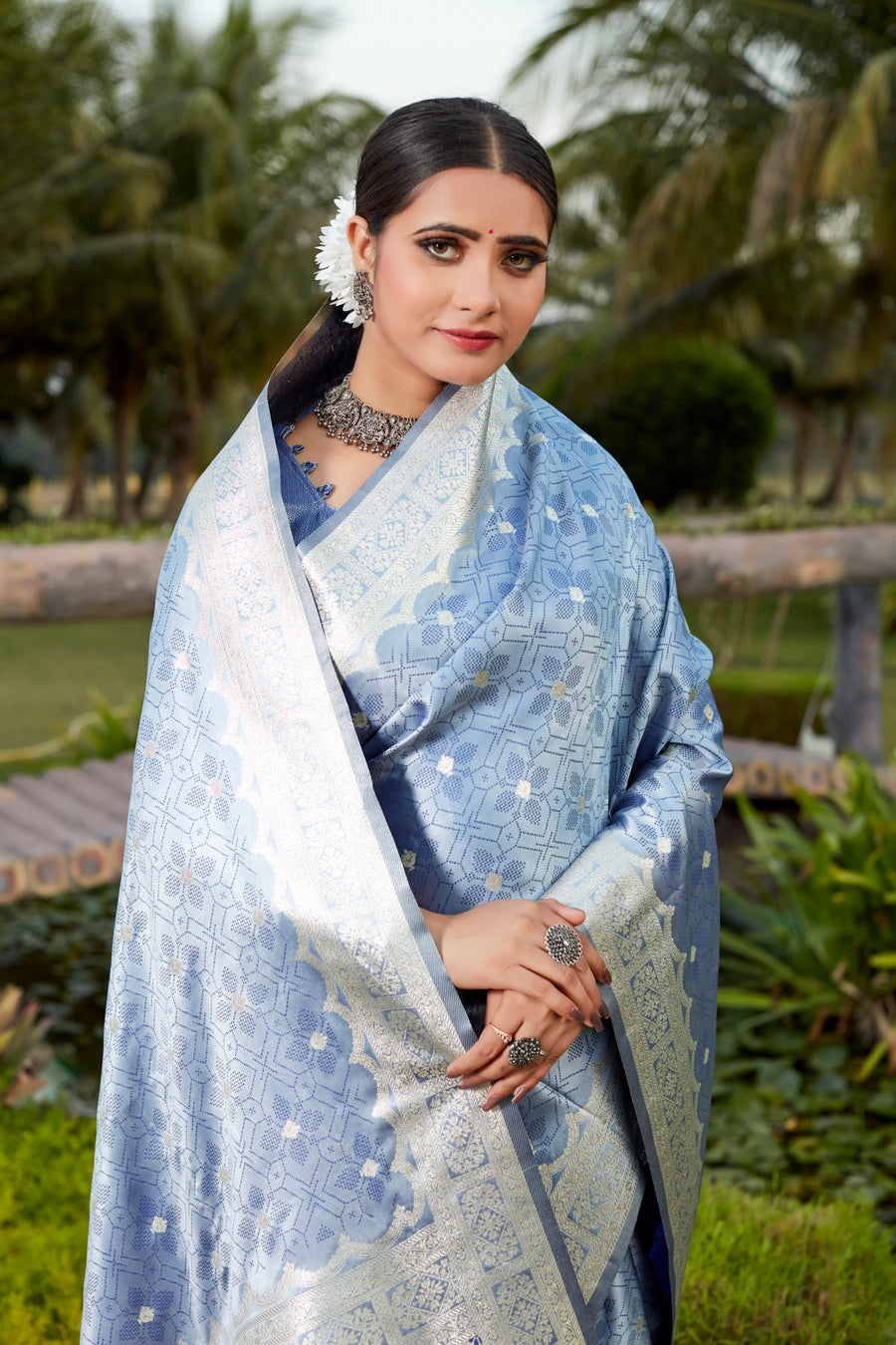 Elegant blue Kanjivaram silk saree with intricate butta work and designer border, perfect for weddings.