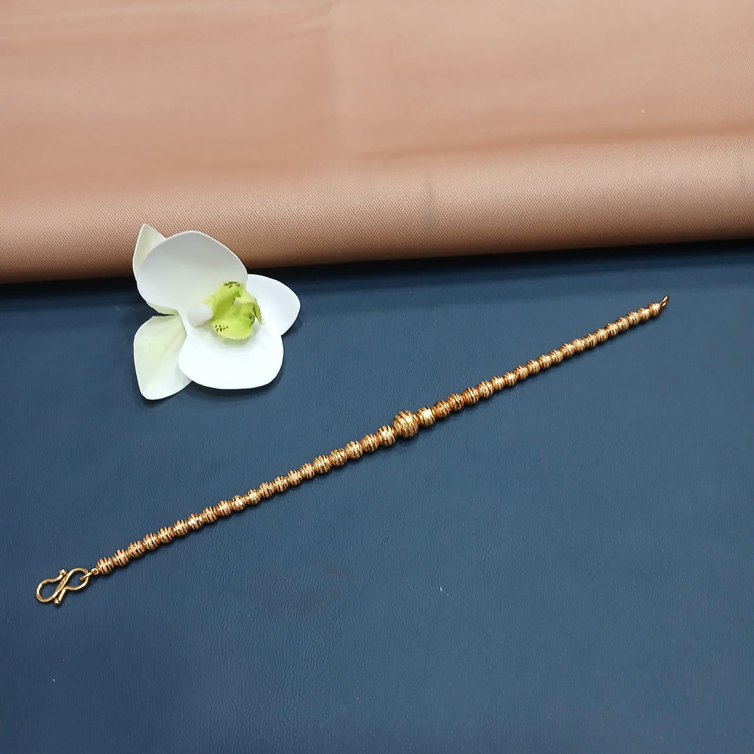 Dainty golden bracelet with a minimalist bar design, perfect for gifting.