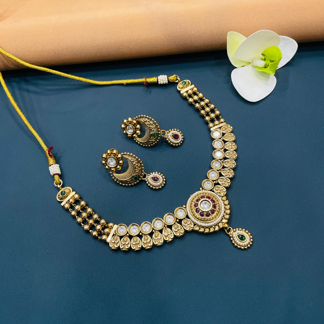 Elegant Indian choker in gold, with intricate antique detailing for cultural and festive attire.