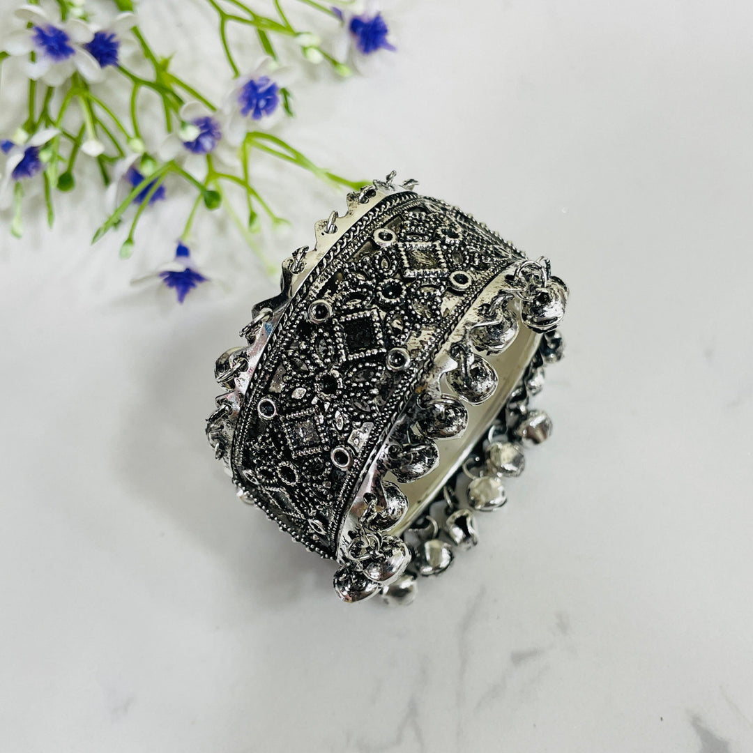 Dramatic oxidised bracelet featuring artistic engravings, perfect for statement wear.