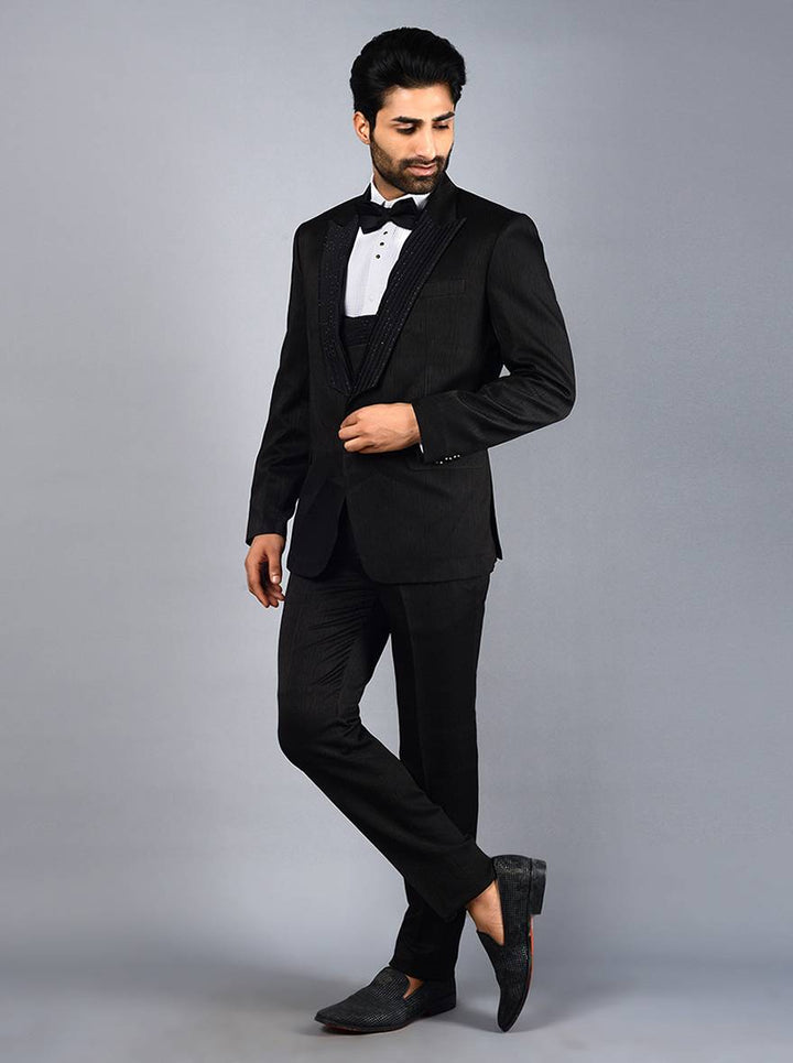 Men's black suit featuring intricate self-embroidery and jacquard texture, perfect for weddings and special events.