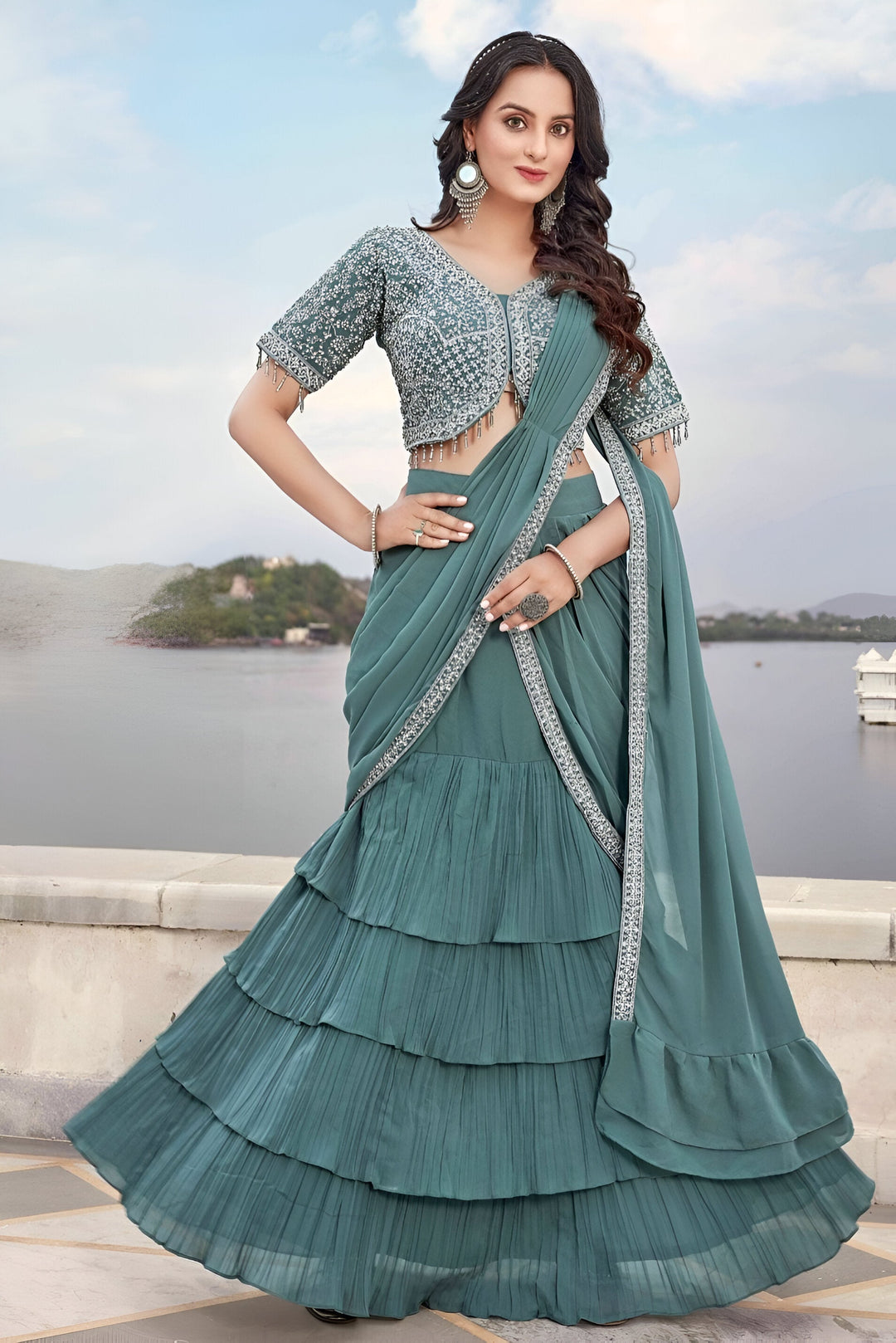 Chic deep sea blue saree in soft georgette with artistic floral patterns, ideal for festive events.