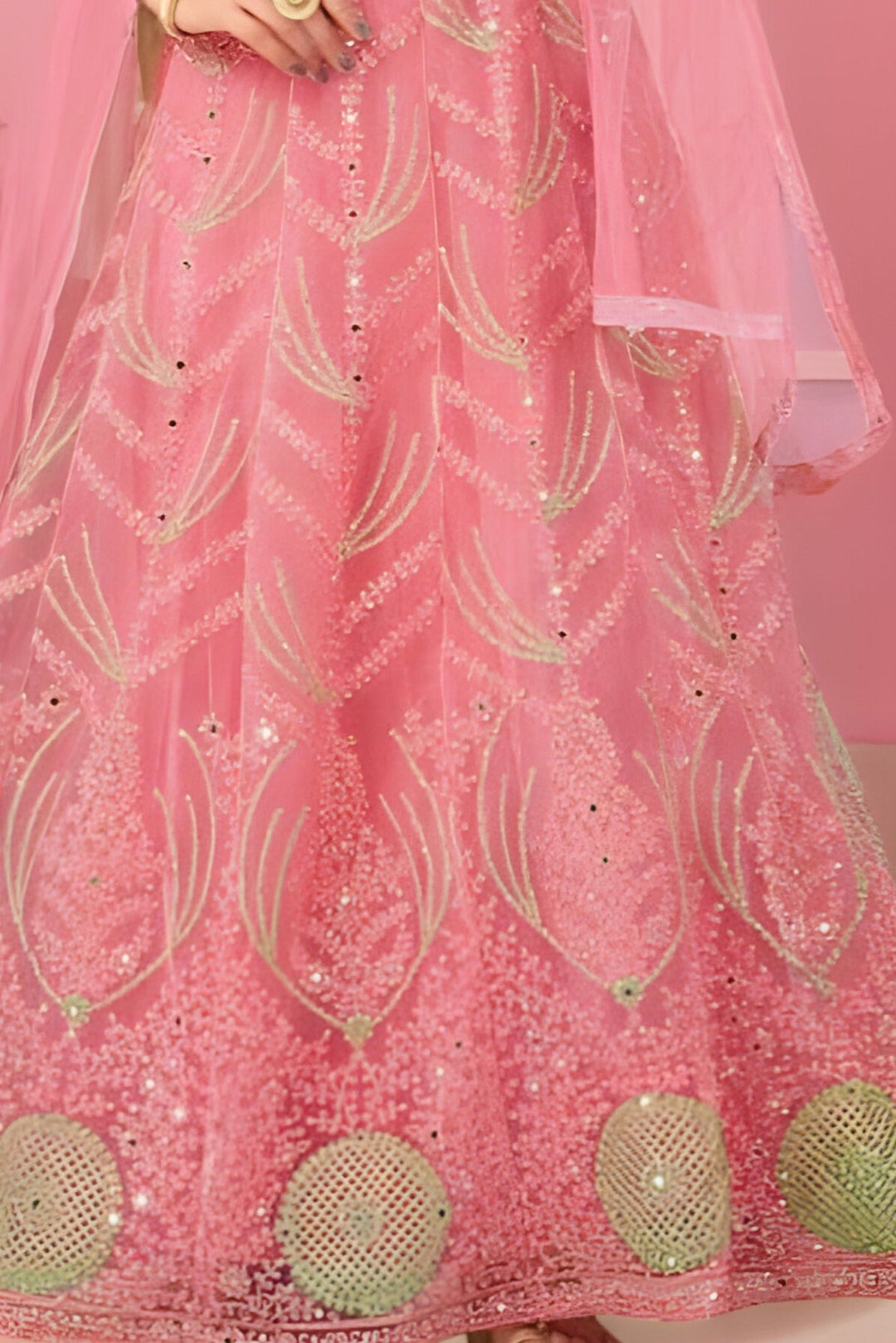 Elegant pink lehenga in net fabric, crafted for party wear and bridal occasions.