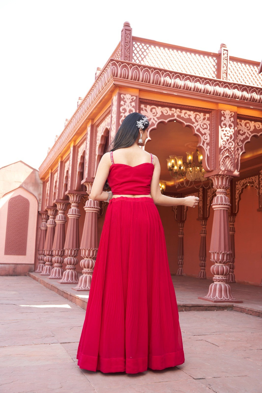 Chic red lehenga featuring a floral crop top in soft georgette, ideal for festive celebrations.