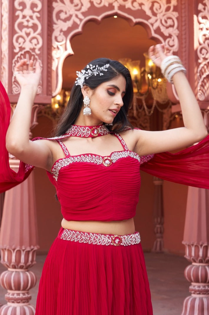 Stylish red georgette lehenga featuring a floral crop top, ideal for festive celebrations and special occasions.