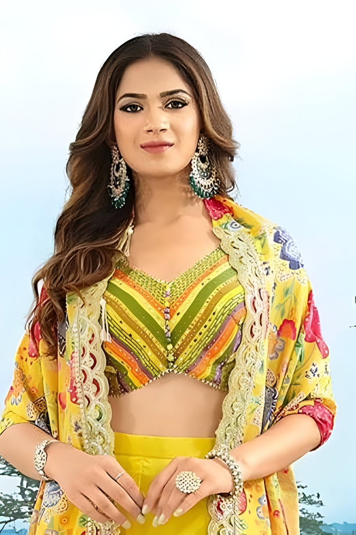 Elegant yellow floral palazzo suit in georgette, featuring a stylish sheer top for a trendy look at events.