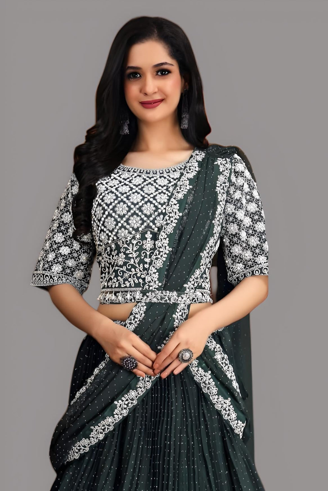 Stunning dark green saree with beautiful floral accents, perfect for celebrations.