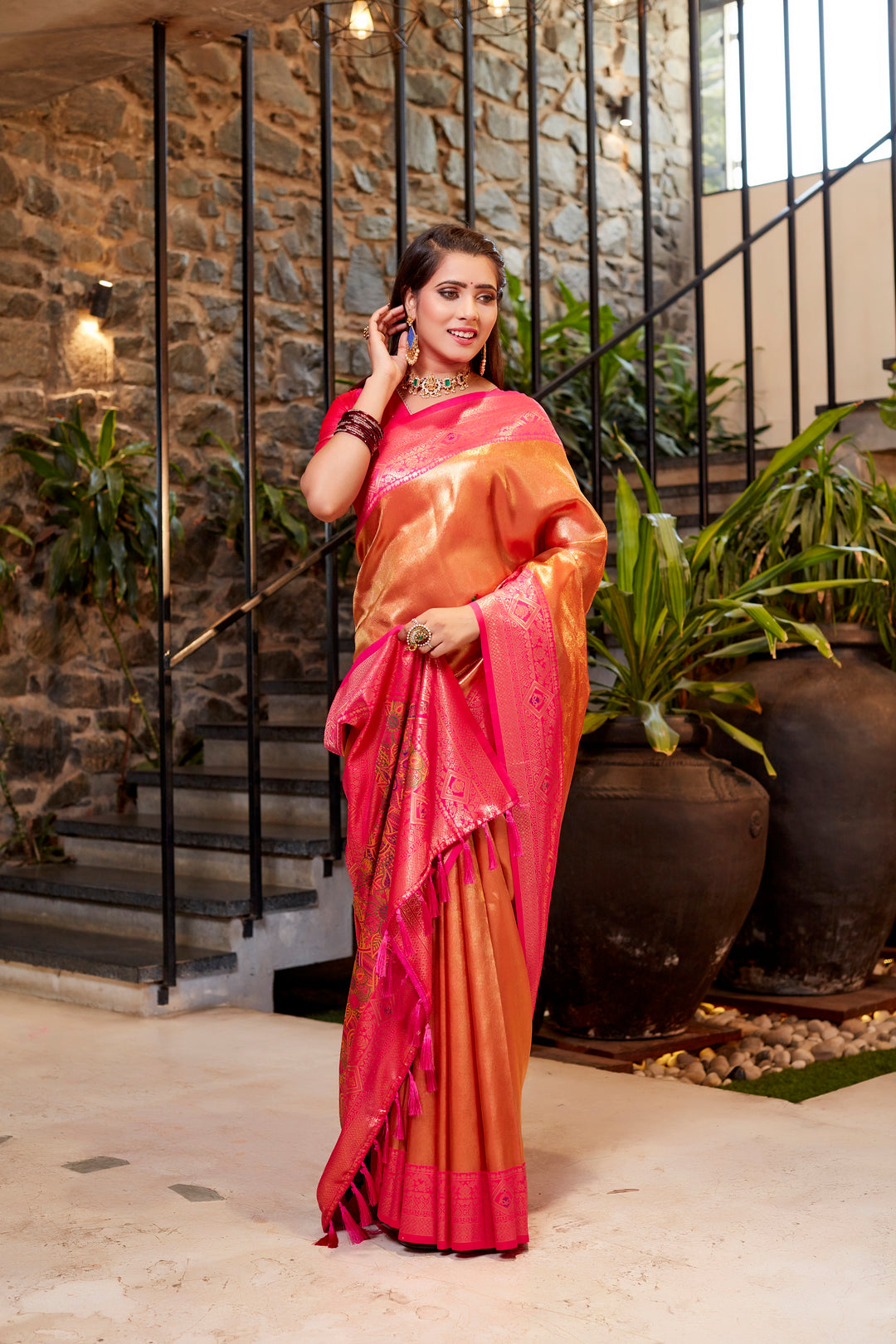 Elegant pink Tissue silk saree with delicate weave and eye-catching contrast border design.