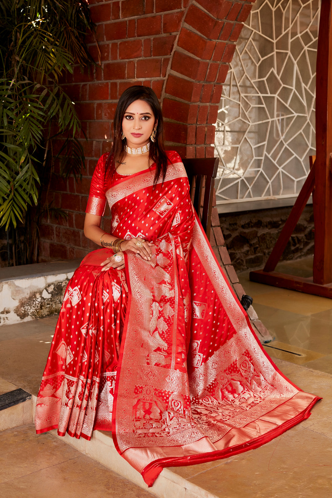 Gorgeous red saree with shimmering finish and finely woven pallu, ideal for creating an unforgettable impression on special occasions.