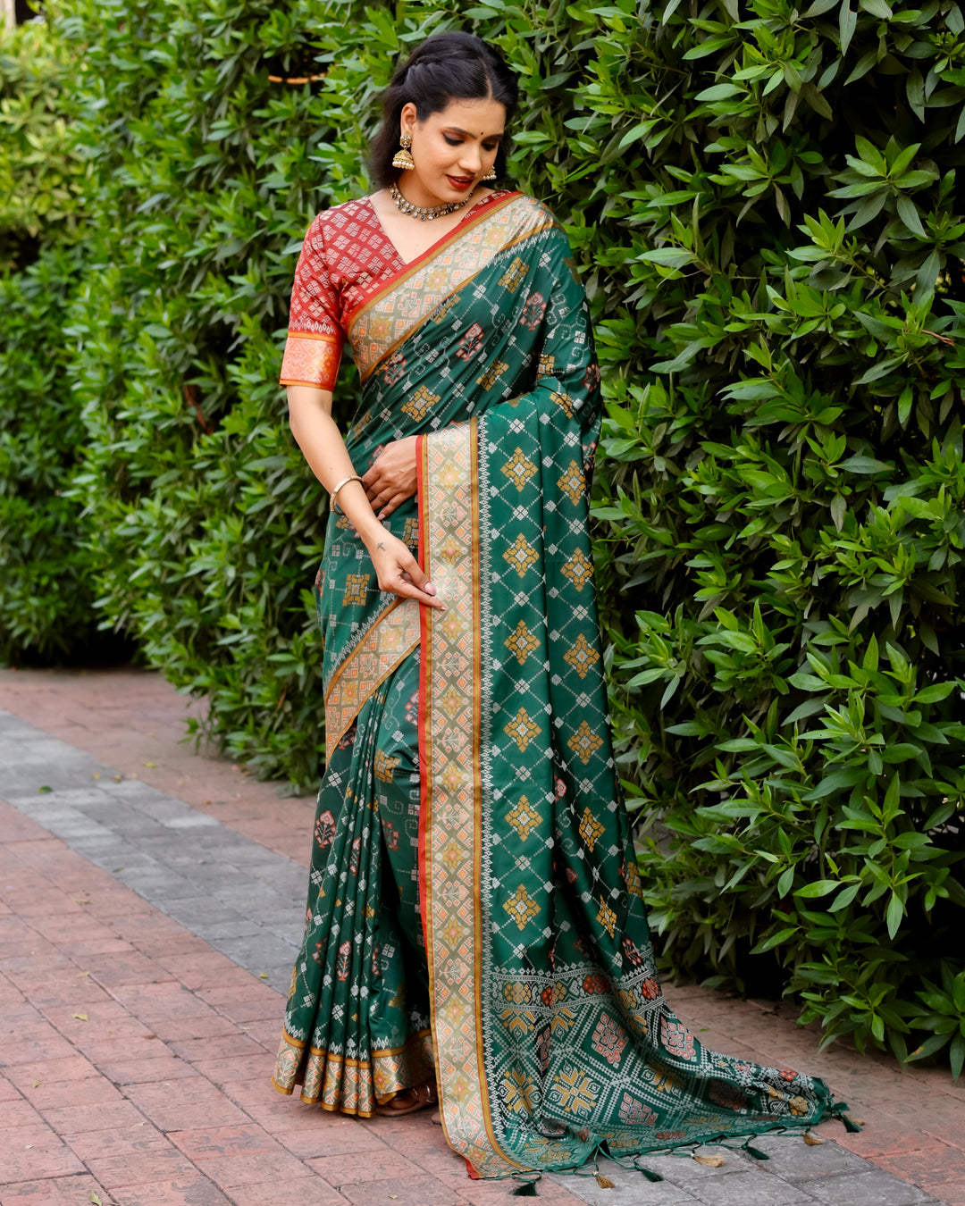 This elegant green Ikkat Patola silk saree combines intricate Ikkat patterns with Zari weaving to create a timeless festive ensemble.