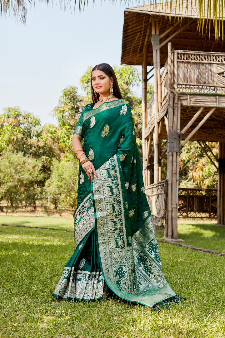 Stunning teal-green satin Kanjivaram saree featuring traditional elephant border details, ideal for cultural celebrations.