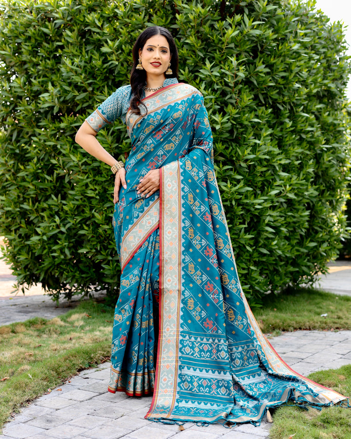 Gorgeous sea-blue Bandhej silk saree with intricate zari woven pallu and matching blouse, ideal for weddings.