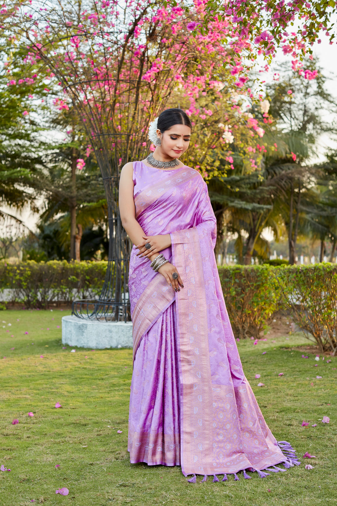 Timeless lavender satin silk Kanjivaram saree with delicate butta designs and woven pallu, perfect for special occasions.