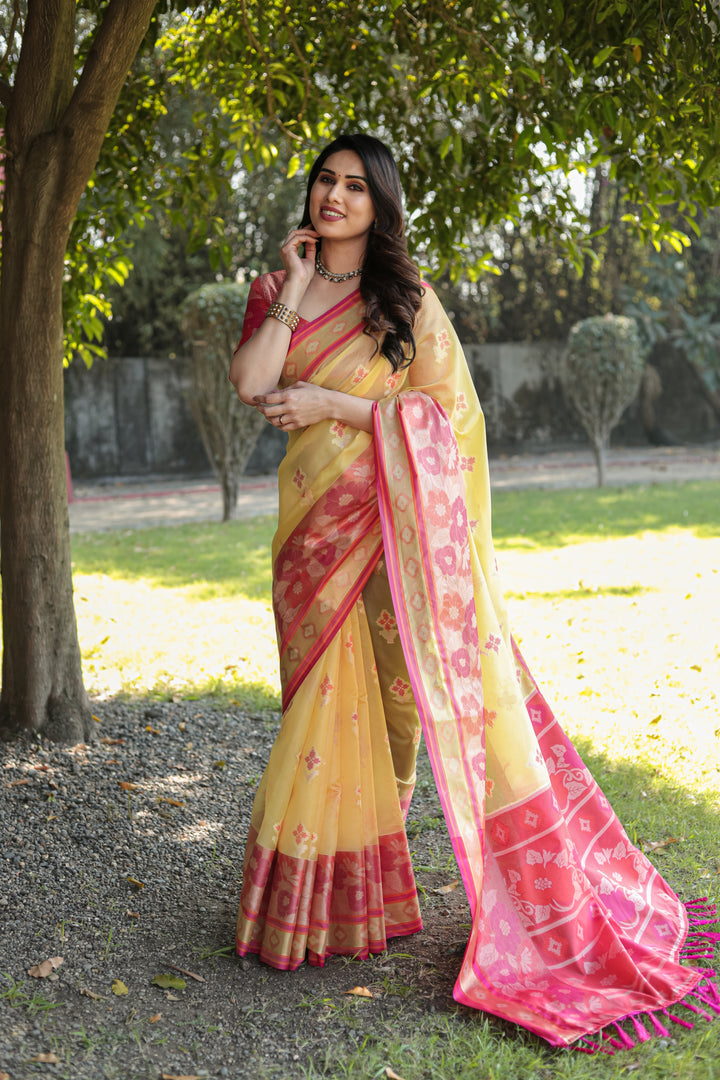 Vibrant yellow Organza saree with beautiful Ikkat weave and matching pallu, perfect for celebrations.