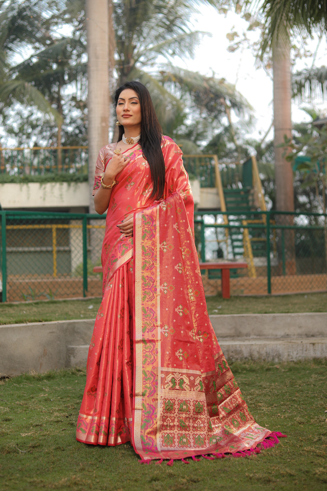 Chic dark-peach organza saree with lightweight Ikkat Patola print, perfect for family celebrations.