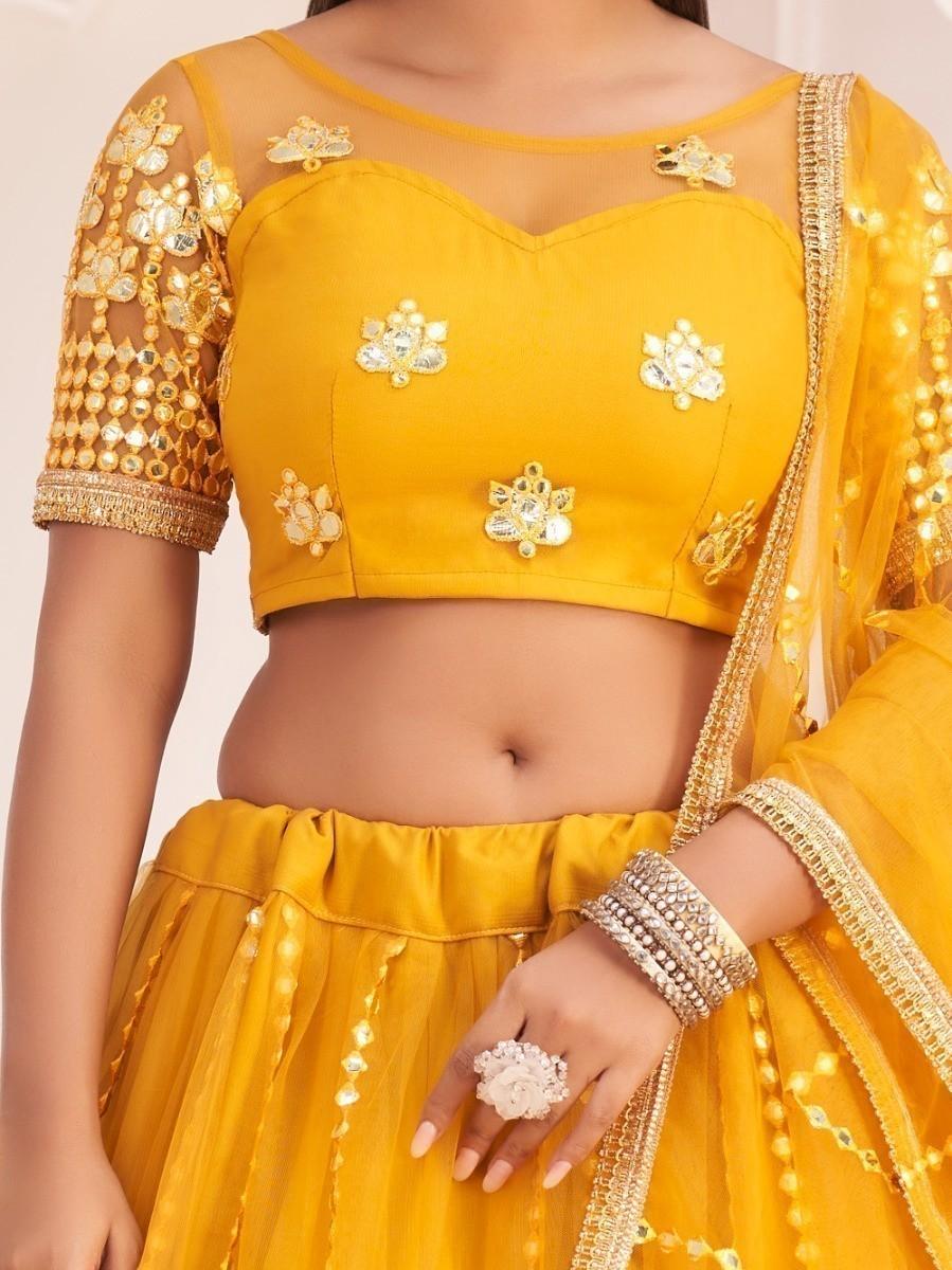 Semi-stitched mustard lehenga choli for weddings, up to 42 inches.