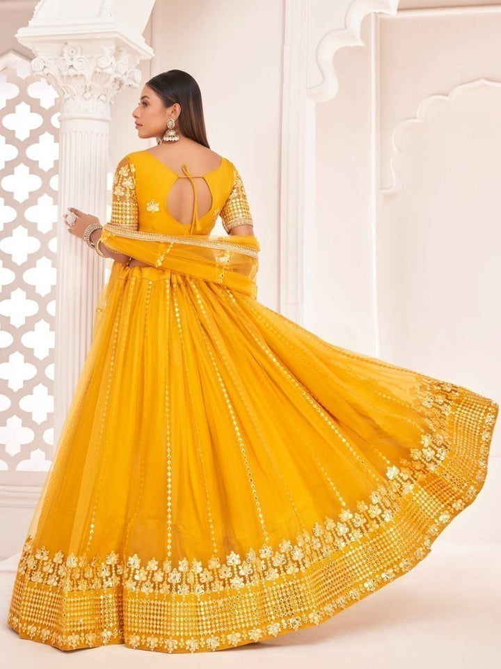 Elegant mustard lehenga with butterfly net material and zari work for weddings.