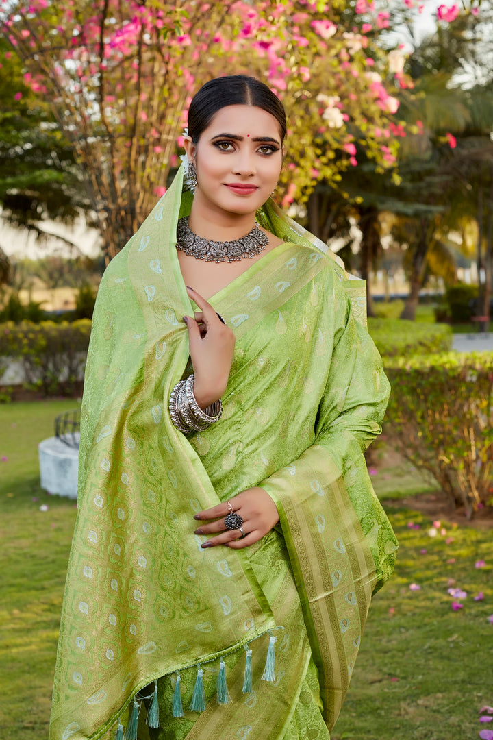 Fresh light-green Kanjivaram satin silk saree featuring intricate butta work and woven pallu, ideal for festivals.