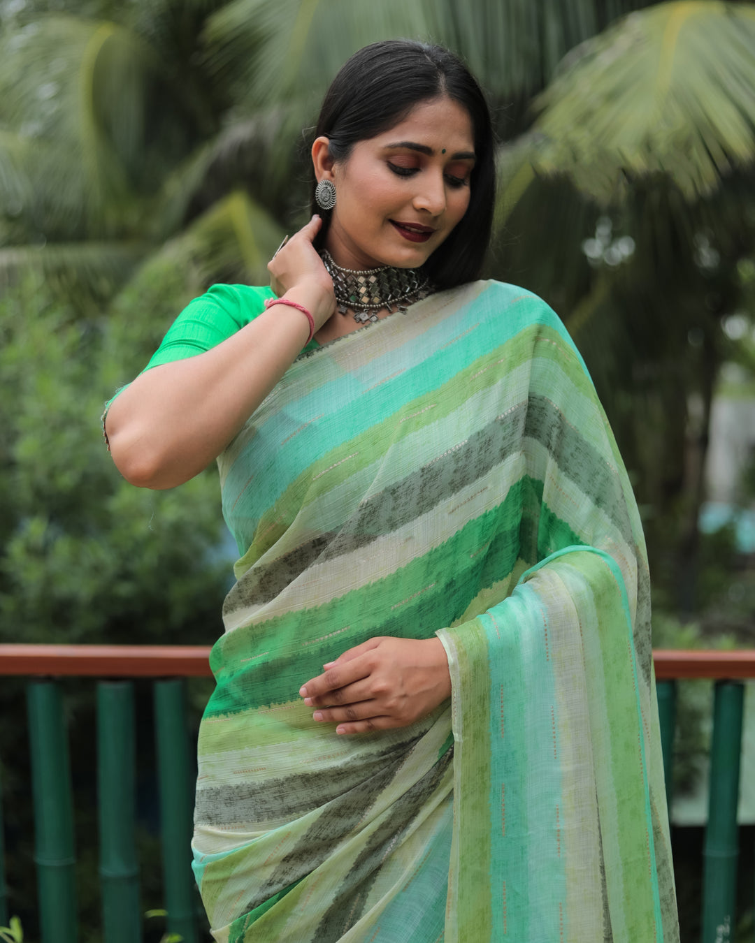 This green Moss chiffon saree is perfect for special occasions, showcasing a soft, graceful design with stunning gold foil detailing.